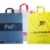 A collection of colorful reusable soft loop shopping bags for wholesale custom orders.