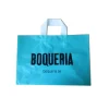 Side perspective of a blue soft loop handle shopping bag showcasing gusset depth.