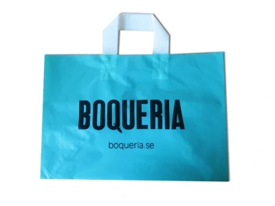 Side perspective of a blue soft loop handle shopping bag showcasing gusset depth.