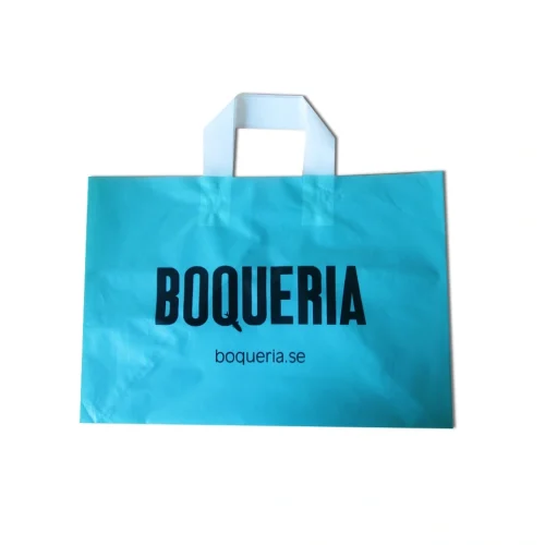Side perspective of a blue soft loop handle shopping bag showcasing gusset depth.