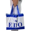 Model carrying a stylish soft loop handle plastic bag, showcasing its use in high-end fashion retail.