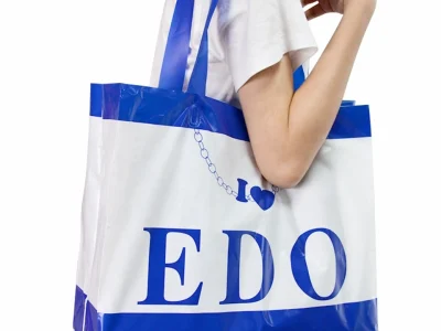 Model wearing a large soft loop handle shopping bag over their shoulder for convenience.