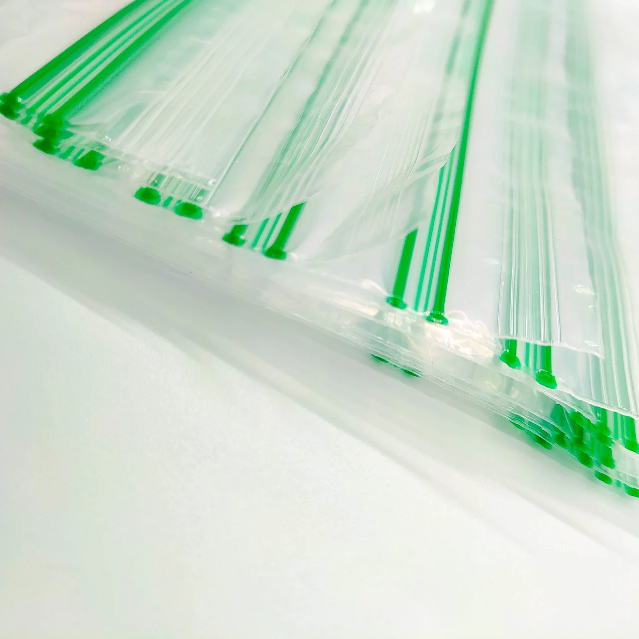 Custom resealable plastic zip bags with green zipper seal